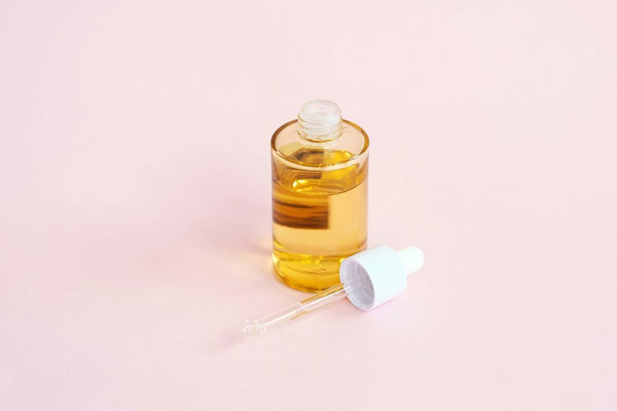 Woman applying vitamin c cream moisturizer to arms for glowing skin
